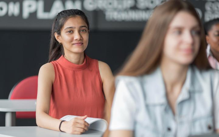 Close-up of a student at her desk paying attention.